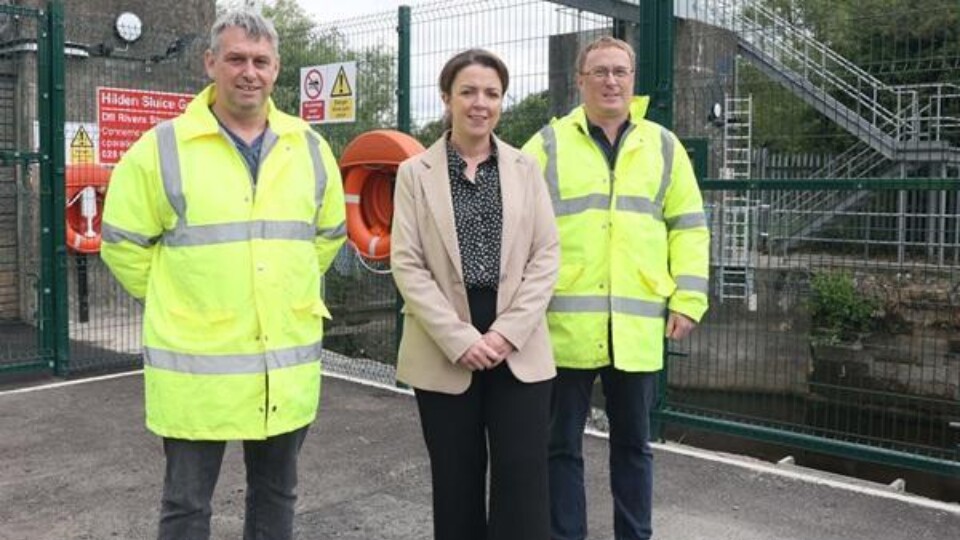 Infrastructure Minister Liz Kimmins pictured with DfI Rivers engineers Mark Scott and Owen McGivern at the Hilden River Control Structure. Picture: FfI
